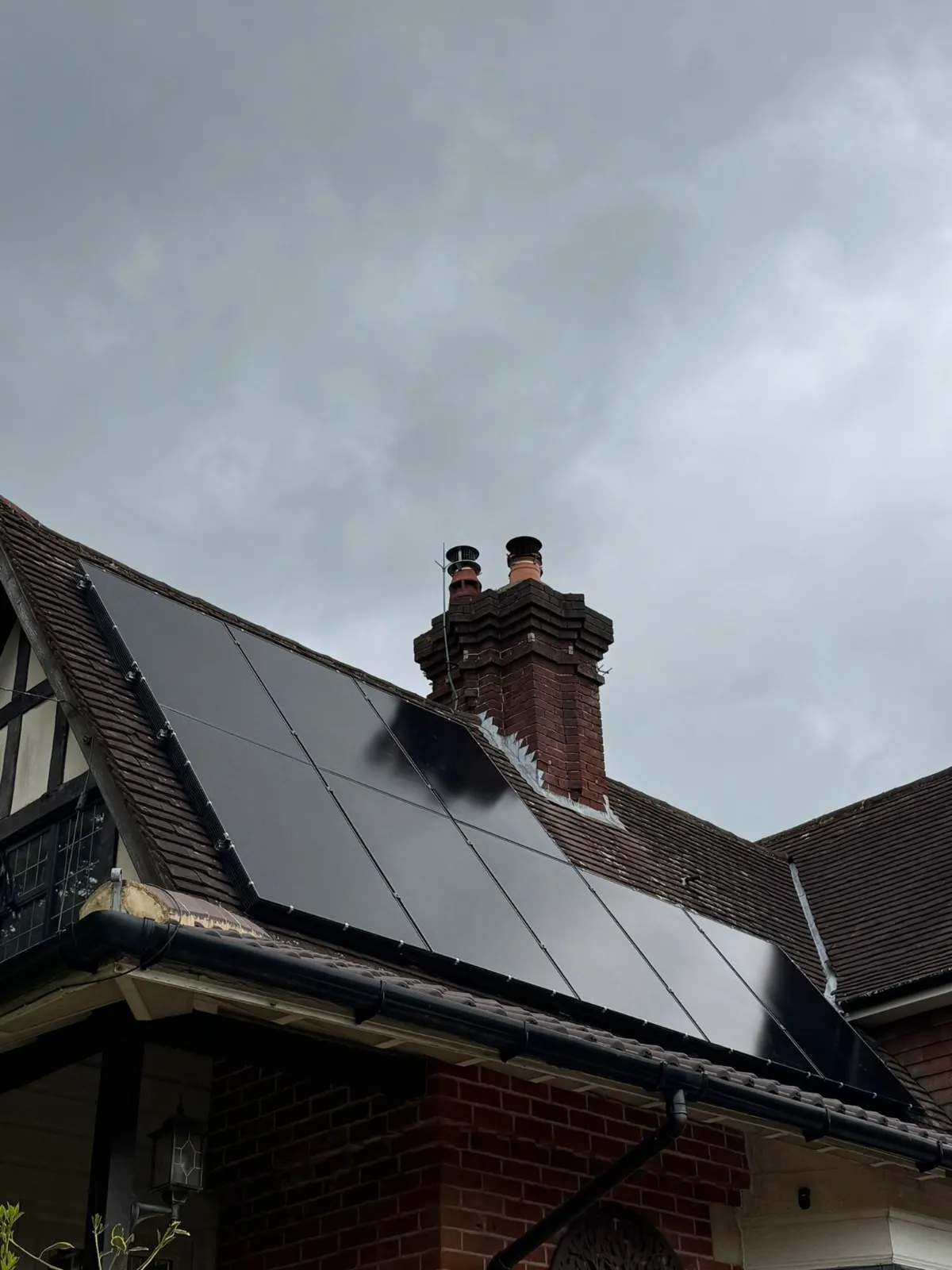 A house with a solar panel on the roof.