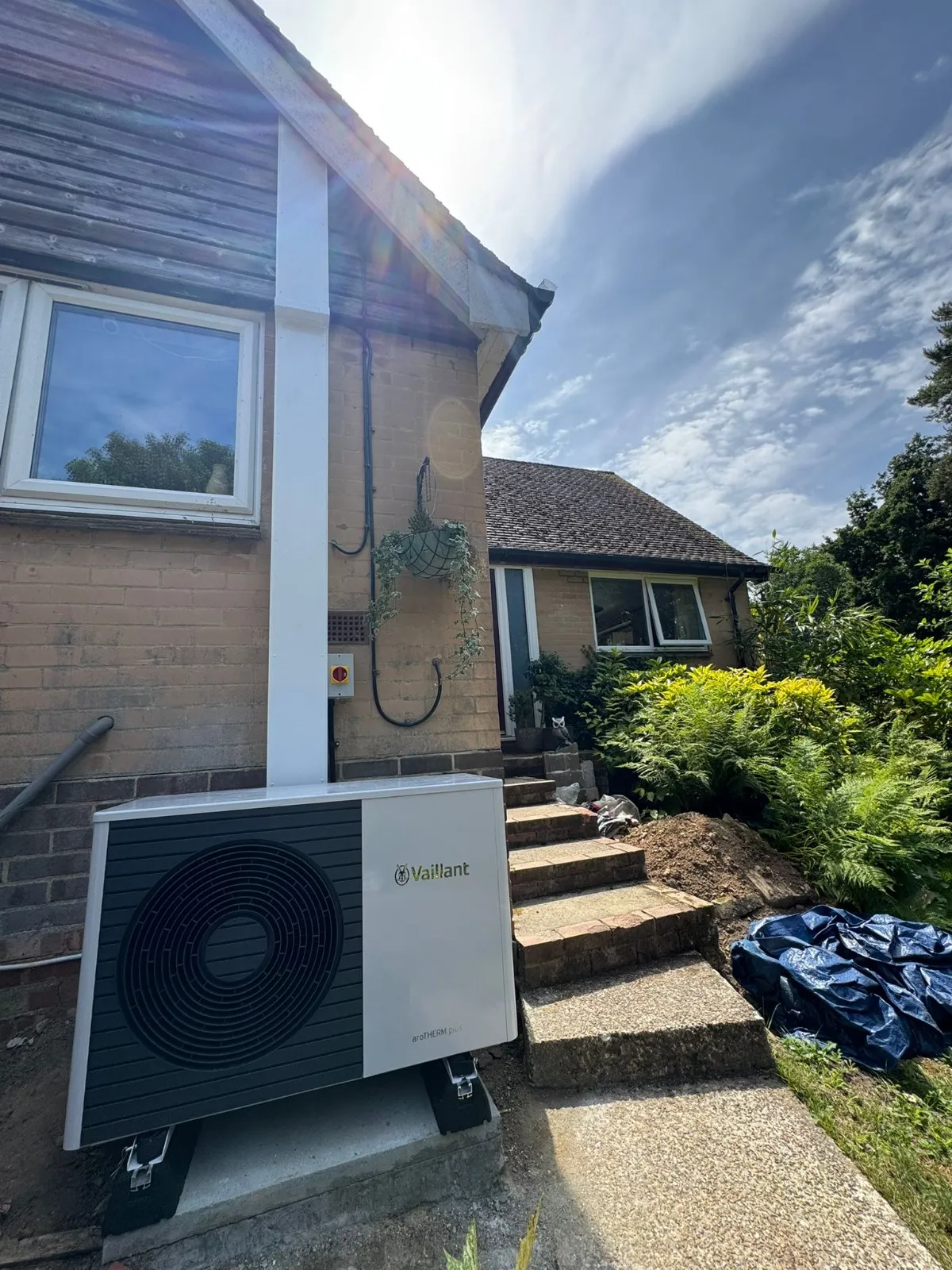 A air conditioner sitting outside of a house.