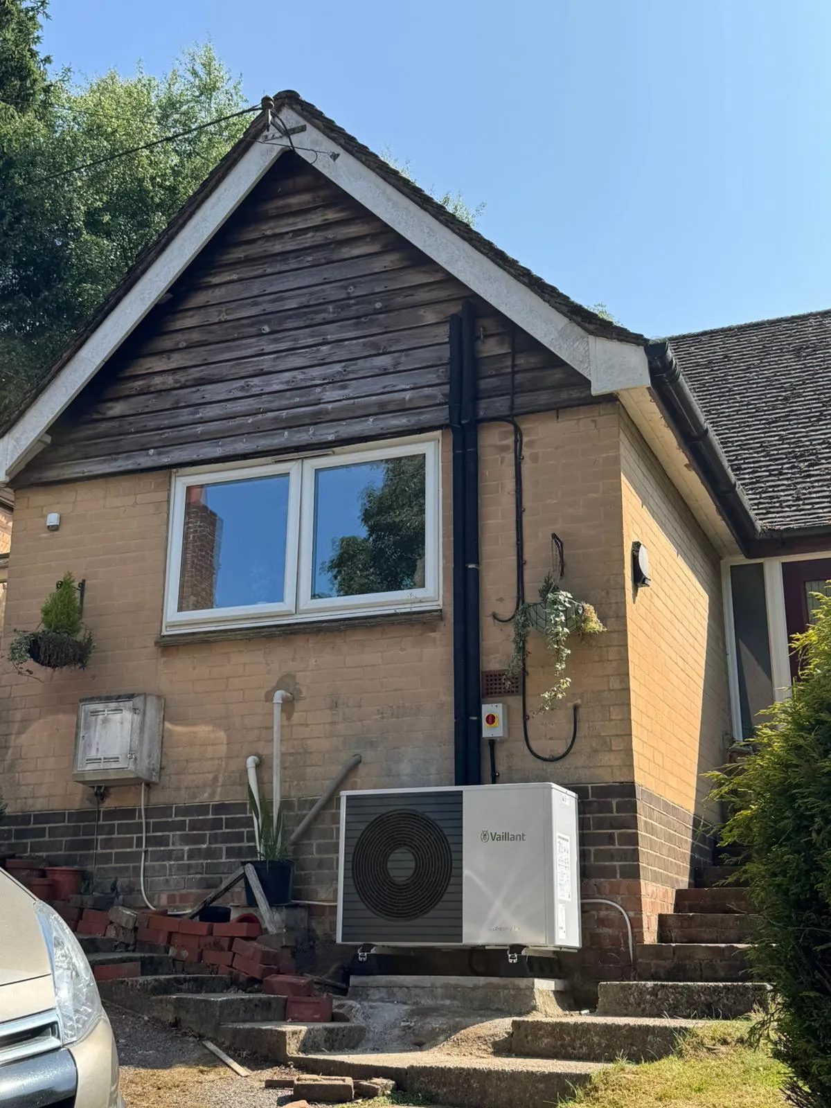 A house with a air conditioner in front of it.
