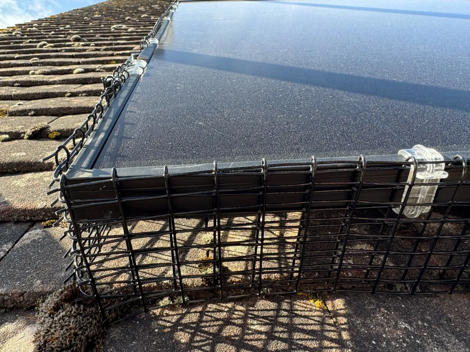 A large metal cage sitting on top of a roof.