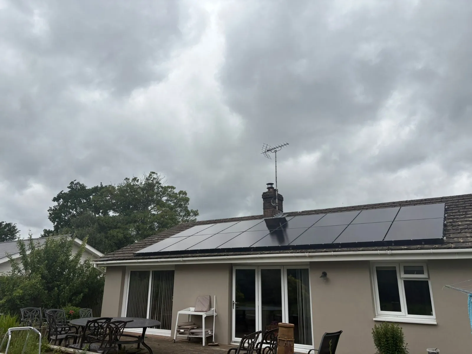 A house with a solar panel on the roof.
